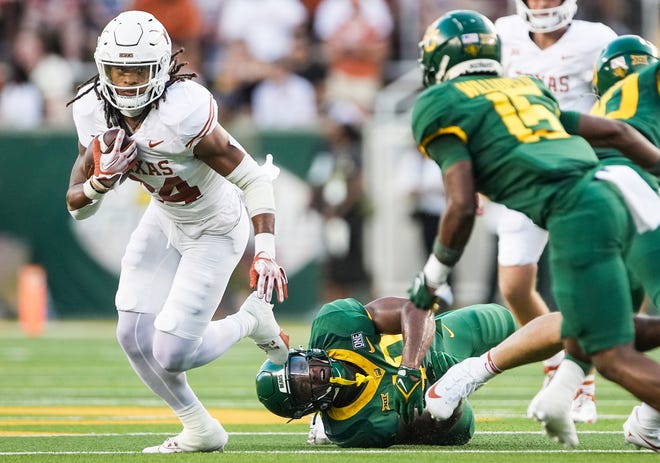 Texas running back Jonathon Brooks (24) looks for room to run against Baylor defense in the first quarter of an NCAA college football game, Saturday, Sept. 23, 2023, in Waco, Texas.