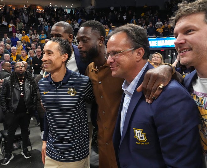 Marquette head coach Shaka Smart, left, poses with former NBA All Star and Marquette basketball player Dwayne Wade, former head coach Tom Crean and Travis Diener Wednesday, January 18, 2023 at Fiserv Forum in Milwaukee, Wis. Marquette beat Providence 83-75. The school was honoring members of the 2003 NCAA Division I men’s basketball semifinalist team.