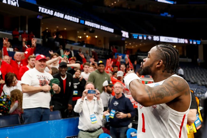 Houston's Jamal Shead (1) celebrates with Houston fans after Houston defeated Texas A&M 100-95 in overtime in the second round of the 2024 NCAA Tournament at FedExForum in Memphis, Tenn., on Sunday, March 24, 2024.