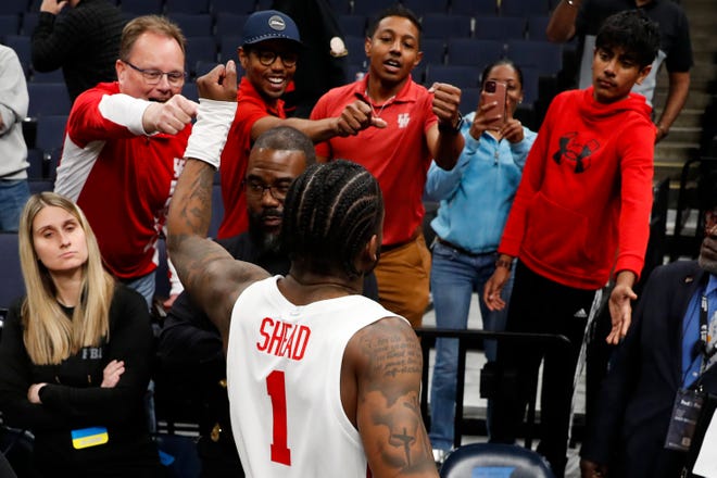 Houston's Jamal Shead (1) fist bumps Houston fans after Houston defeated Texas A&M 100-95 in overtime in the second round of the 2024 NCAA Tournament at FedExForum in Memphis, Tenn., on Sunday, March 24, 2024.