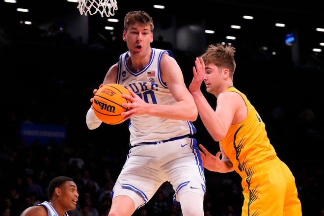 Duke Blue Devils center Kyle Filipowski (30) grabs a rebound against the Vermont Catamounts in the first round of the 2024 NCAA Tournament at the Barclays Center.