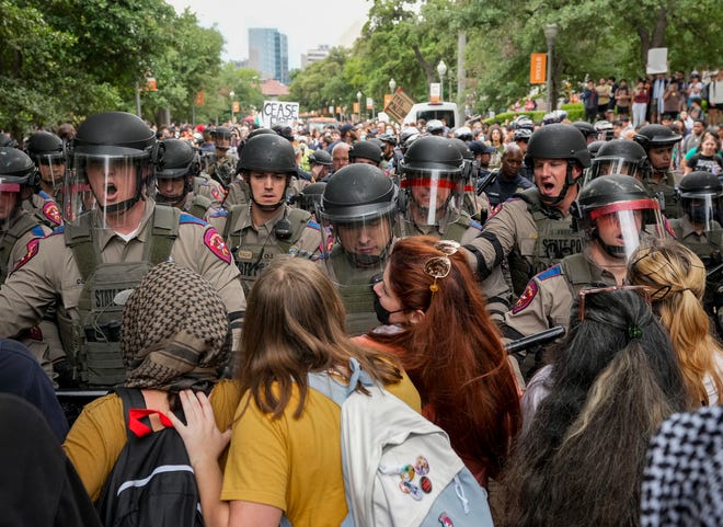 State troopers in riot gear try to beak up a pro-Palestinian protest at the University of Texas Wednesday April 24, 2024.